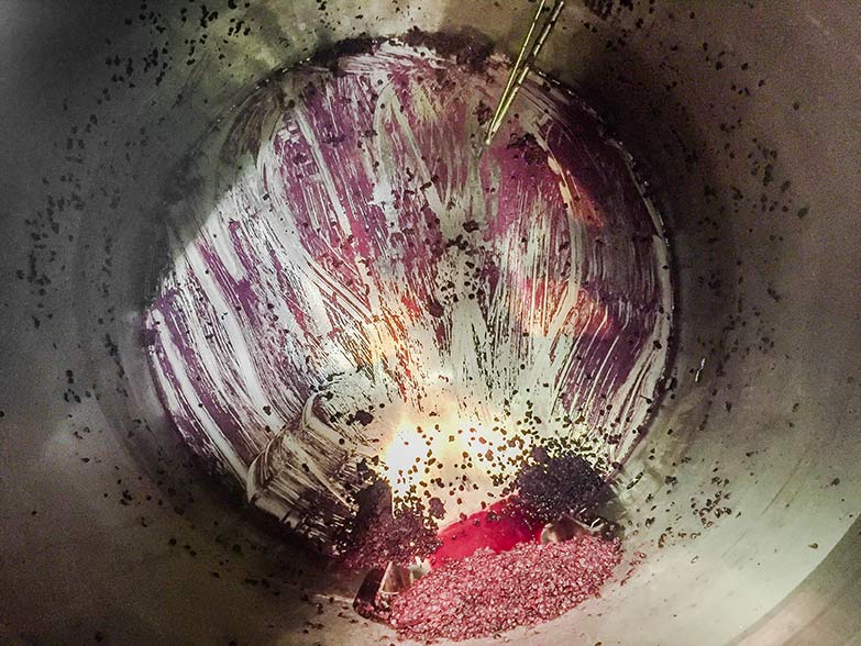Winery Fermentation Tanks covered in leftover grape debris and wine residue