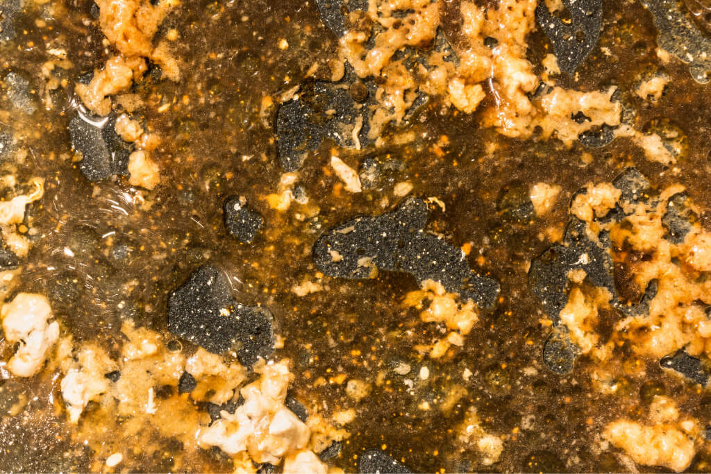 A detail of Fat residues in the potato chip processing tank, dirty tank walls.
