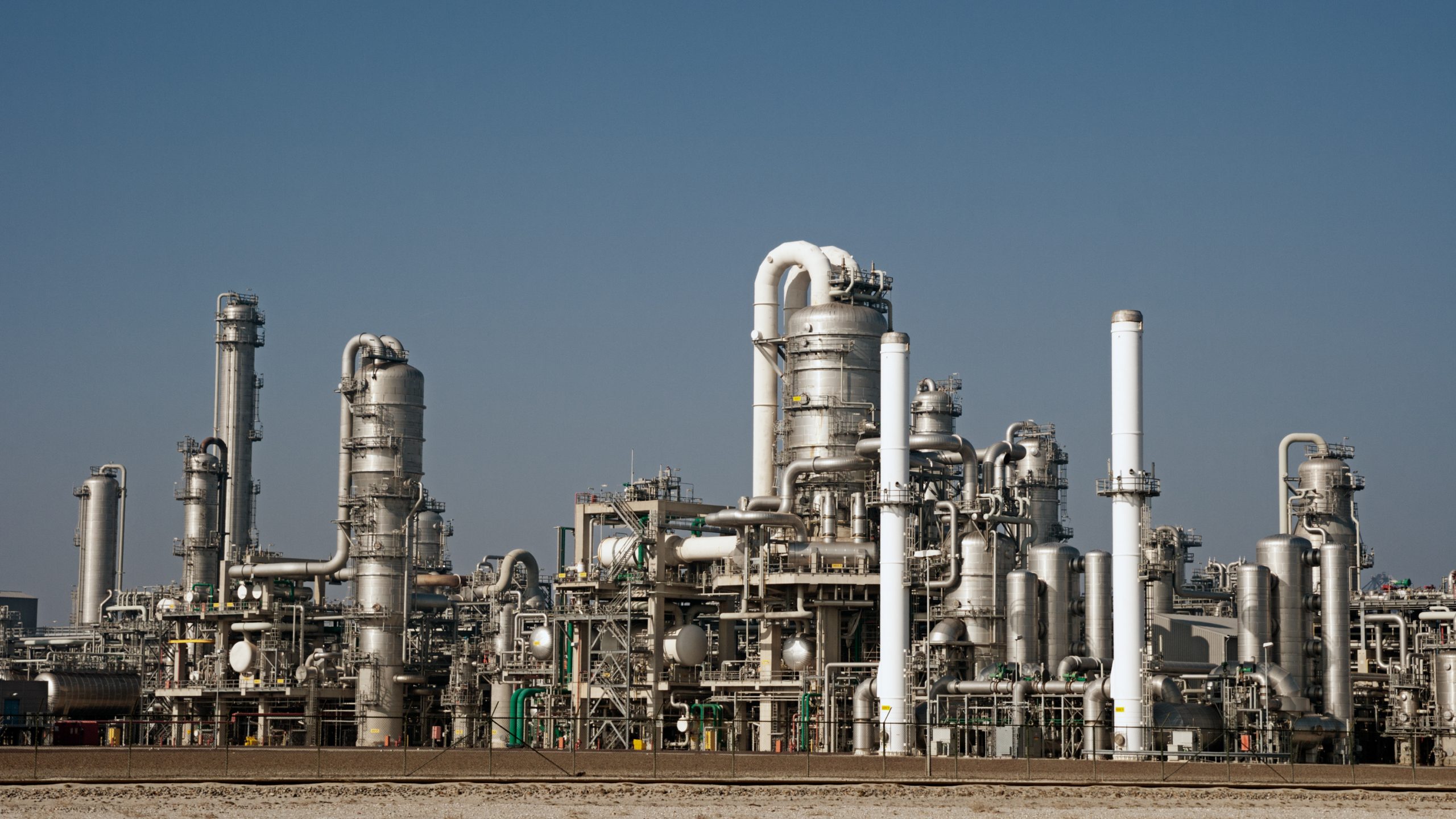 A petrochemical processing plant with various processing columns and towers.Industrial pipelines of an oil-refinery plant
