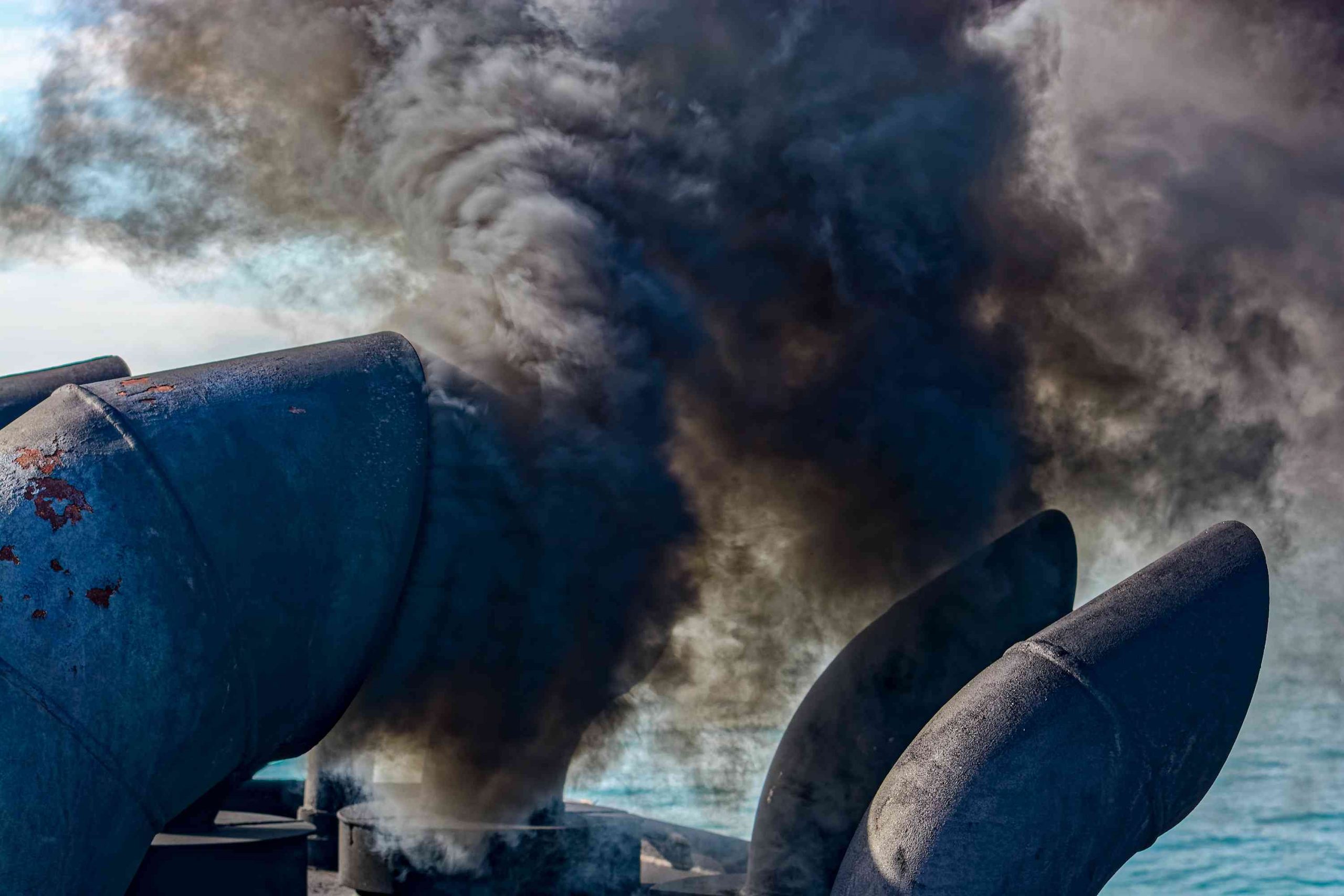 Image of smokestacks on ship polluting the air.