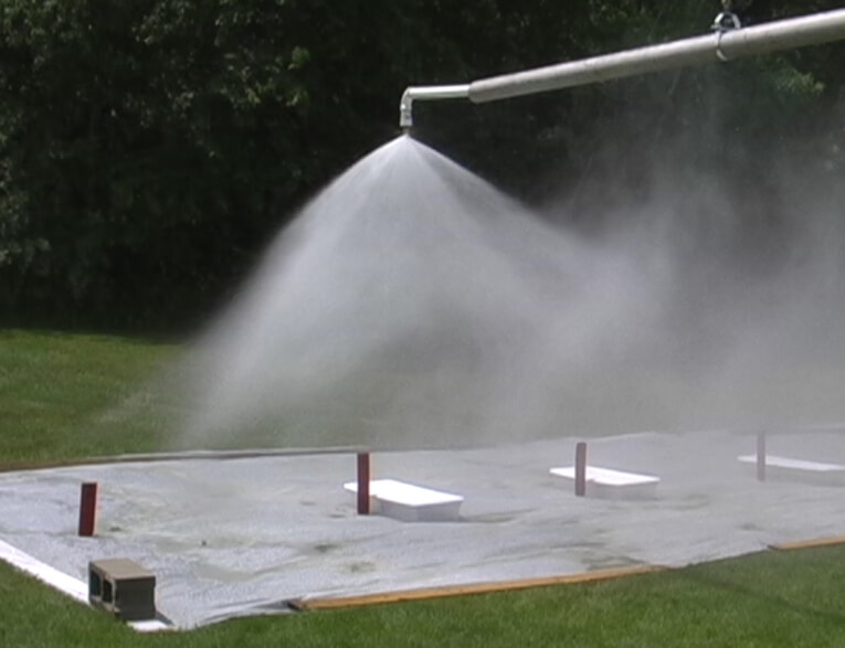 A physical model test measuring the affects of wind drift on fire protection nozzle spray coverage.